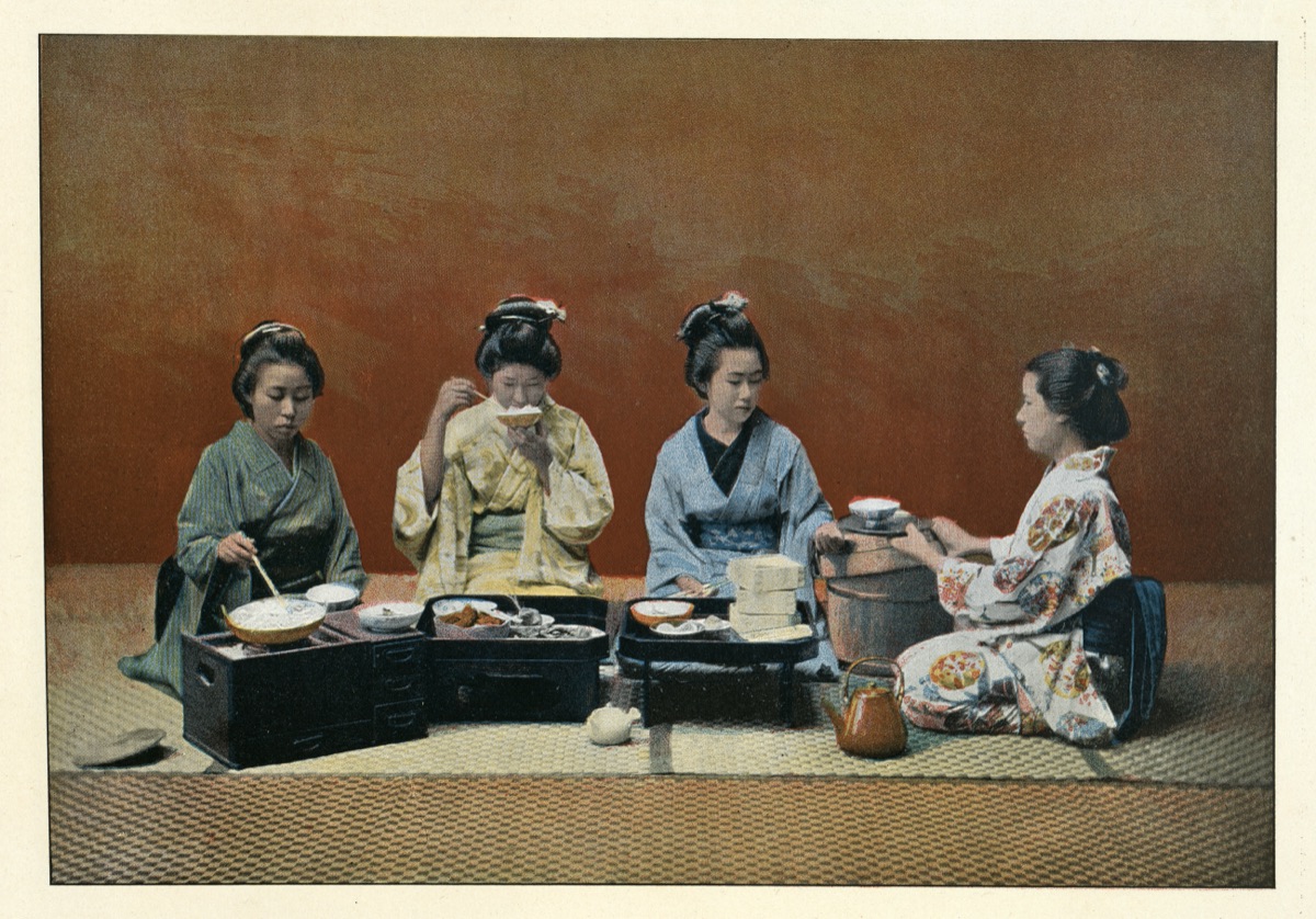 A meal in kimono, hand-tinted photograph